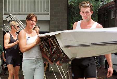 Jennifer Capriati helps carry a rowing skull out of the boatshed to the Yarra River with the Australian under 23 Olympic rowing team during a break from the Australian Open 2000